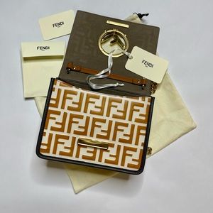 KANI F - Cognac leather bag w/ flap & decorated with an F in Fendi metal logo.